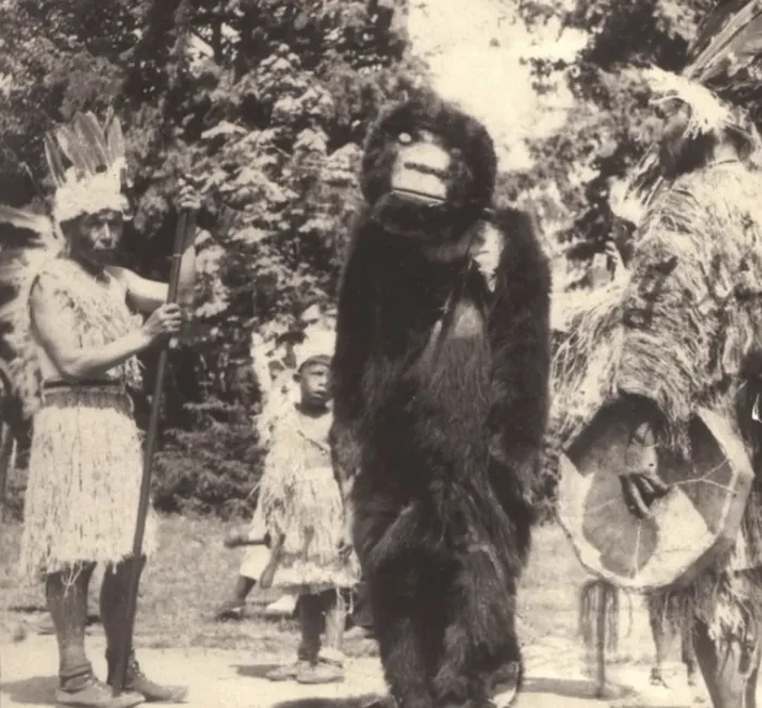 Historic photograph of a Sasquatch figure with members of a tribe